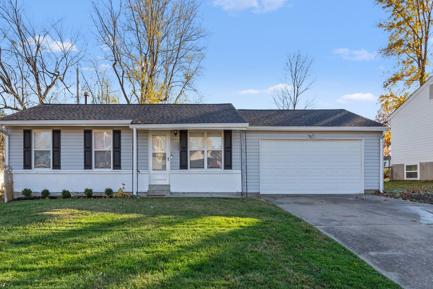 O'Fallon MO vacation rentals: The Secret Sojourn, a single-story ranch home with gray siding, dark shutters and a two-car garage in O'Fallon, Missouri
